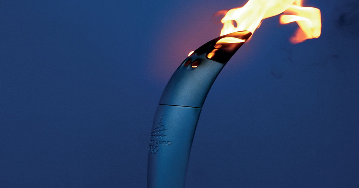A sculpted metal torch etched with the words ‘Torina 2006’ emitting a flame from its top