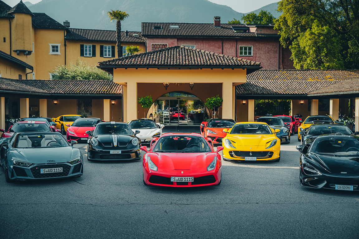 The Ultimate Driving Tours fleet of supercars sitting outside a palatial European villa