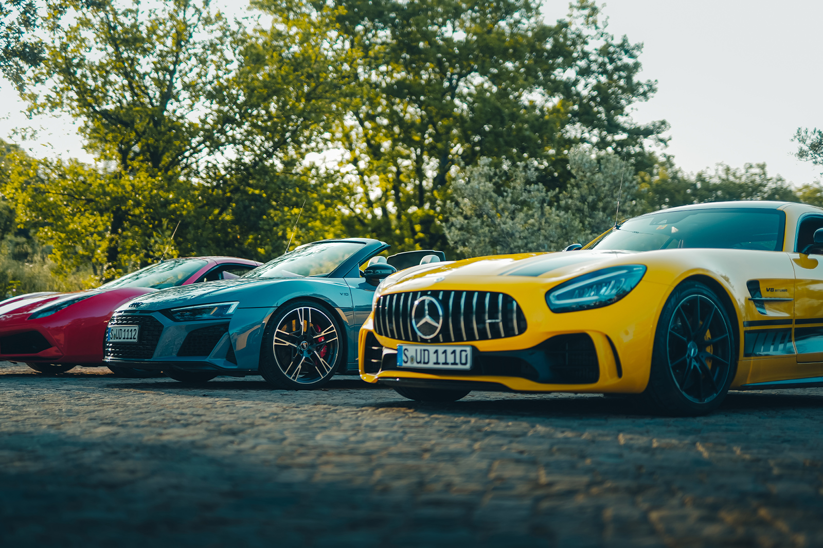 A trio of supercars in red, yellow and blue awaiting Ultimate Driving Tours’ guests