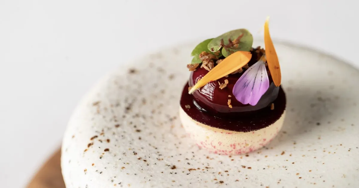 A beautiful dessert with bright colours on a white plate.