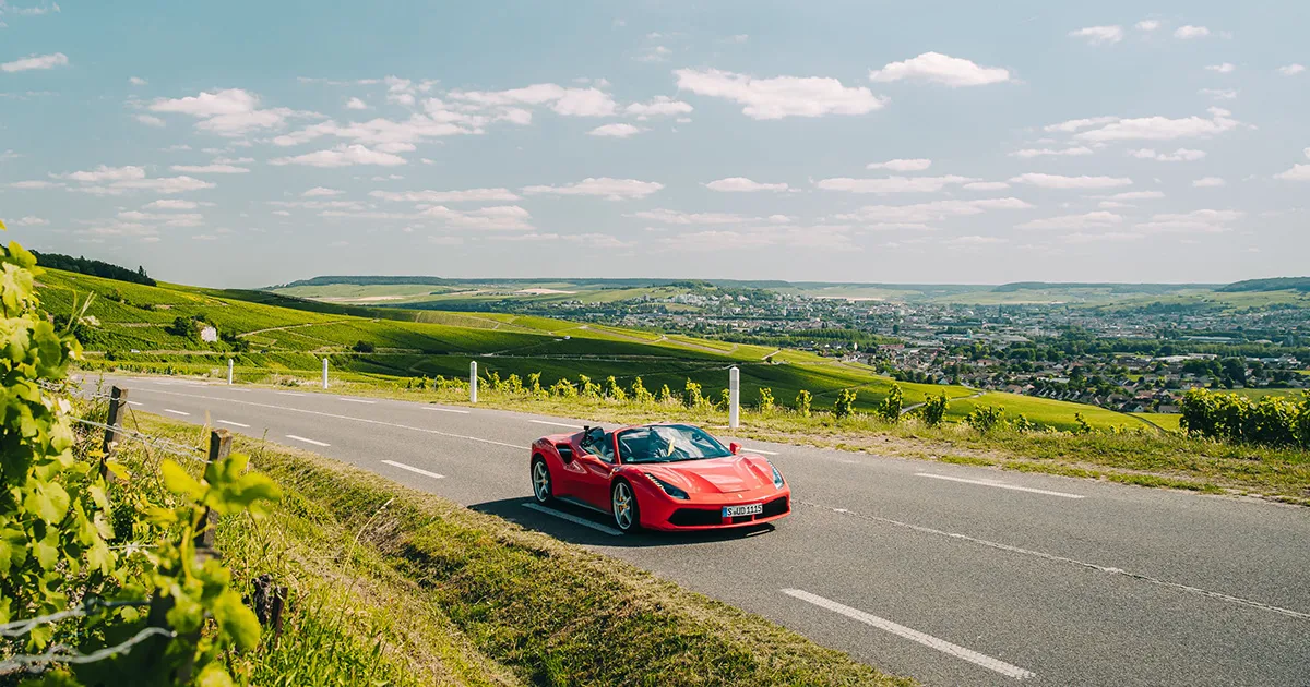 Ferrari supercar driving through Champagne in France on a luxury holiday