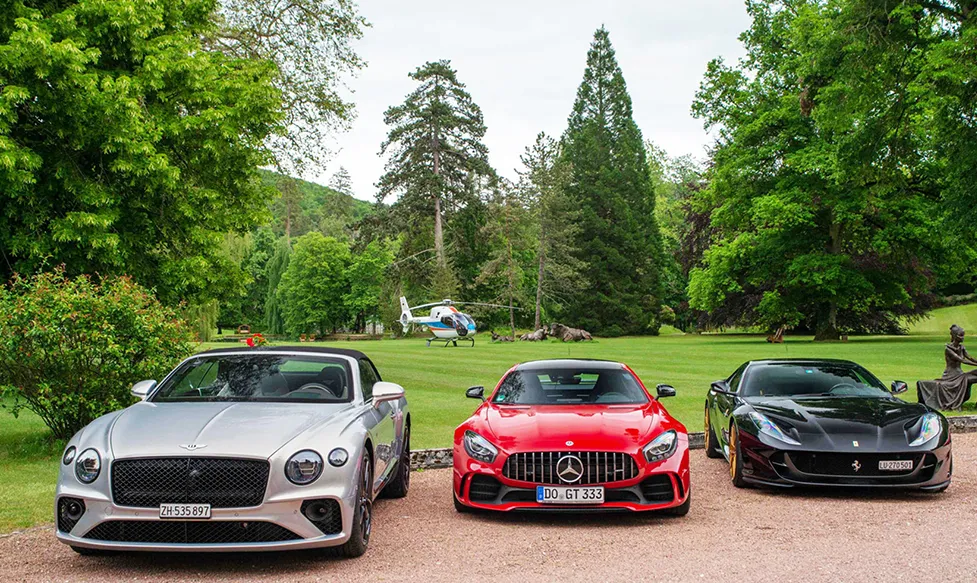 A Bentley, a Medcedes and a Ferrari parked side by side during Ultimate Driving Tours European Supercar Tour