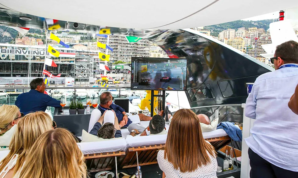 Guests relaxing aboard Ultimate Driving Tours’ private superyacht at the Monaco Grand Prix