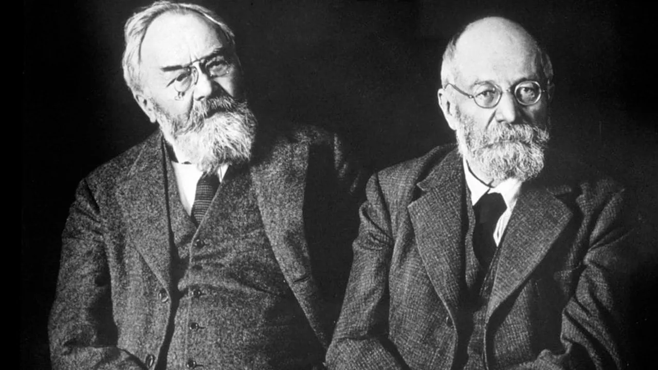 black and white image of two men with beards and glasses in suits, the michelin brothers André and Édouard