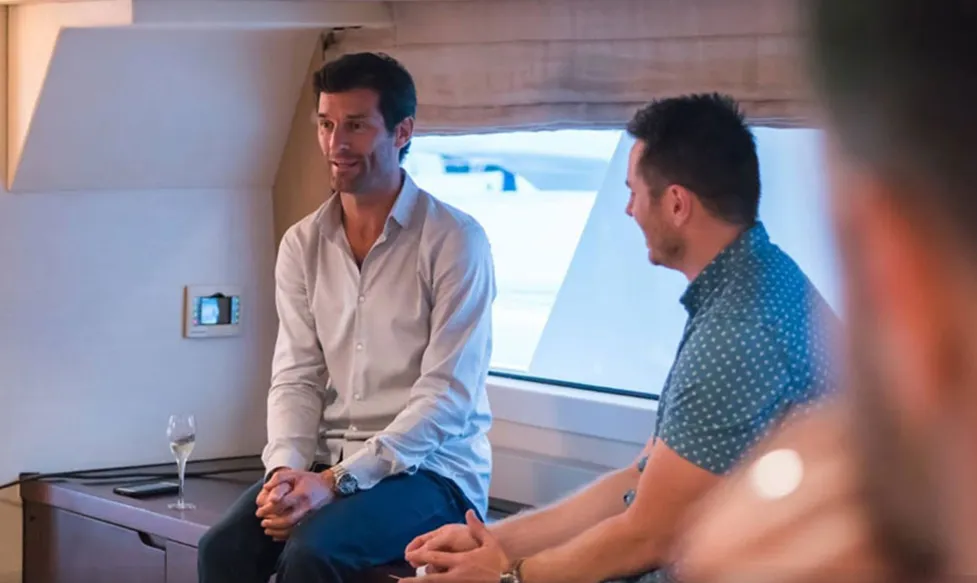 Mark Webber sits and talks with an Ultimate Driving Tours guest during the Monaco Grand Prix weekend