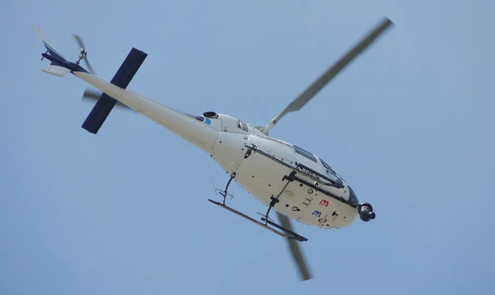 A helicopter, seen from below, as it transports Ultimate Driving Tours’ guests to the race at Monaco