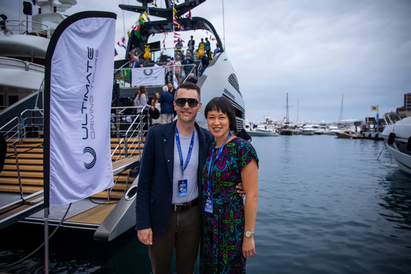 Couple standing in front of a superyacht during the F1 Grand Prix of Monaco